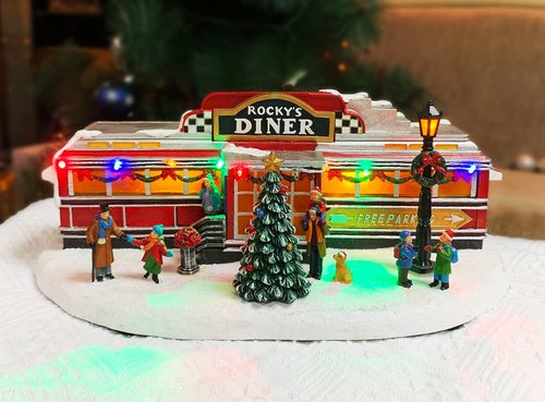 Christmas Village Building, Rocky's Diner, Retro 1950's Diner with LED Lights and Christmas Music - Battery Operated (not included) (optional 4.5V adapter not included) (5.8"H x 13.6"W x 7.1"D)